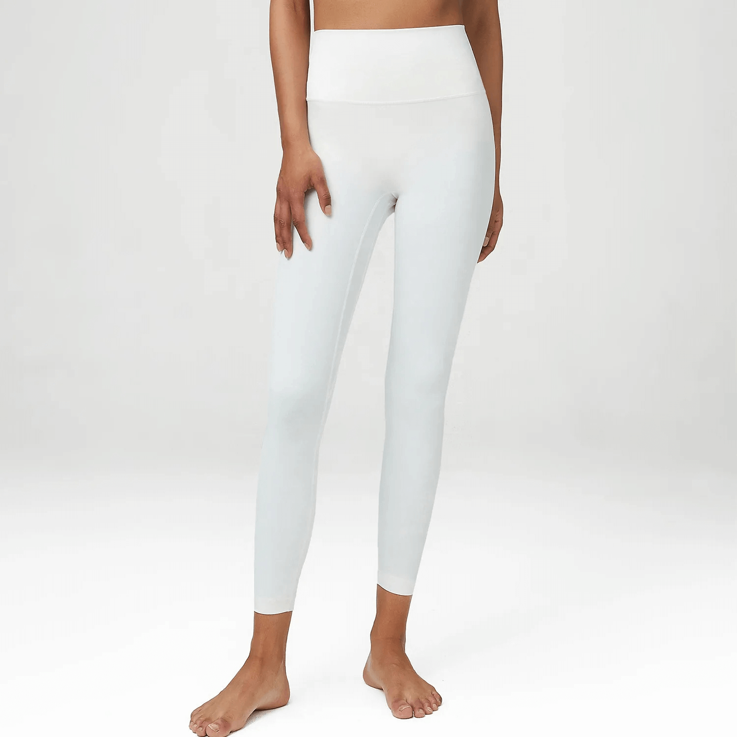 Woman wearing stylish white high-waist yoga leggings SF2110, showcasing flexible LYCRA fabric for yoga and active wear.